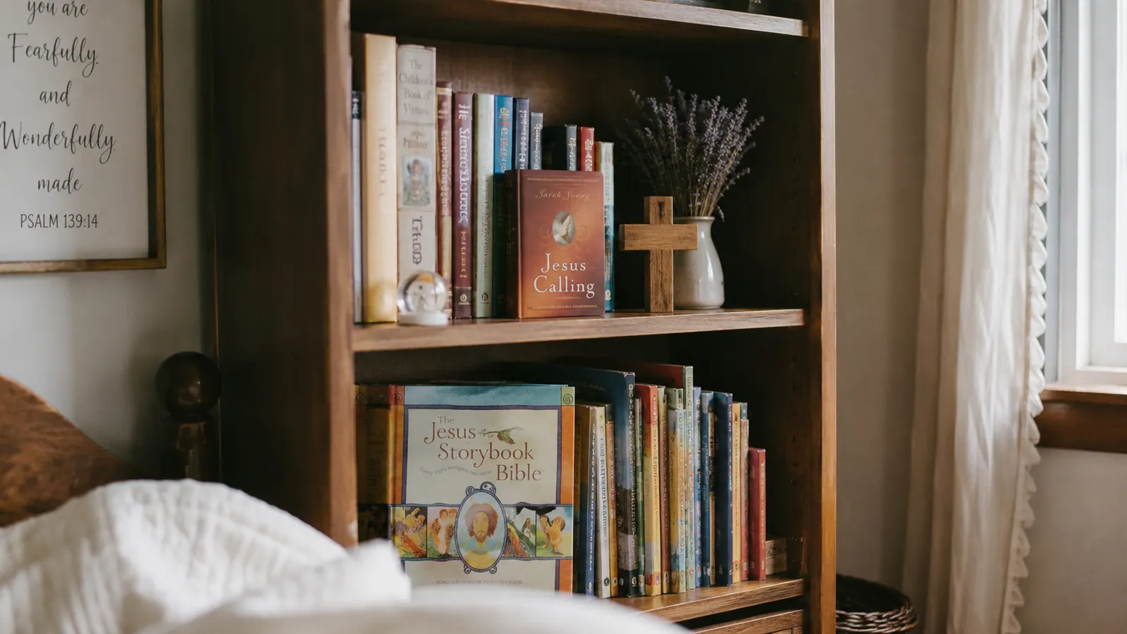 Stack of children's Bibles on a wooden shelf with a small cross and dried flowers nearby